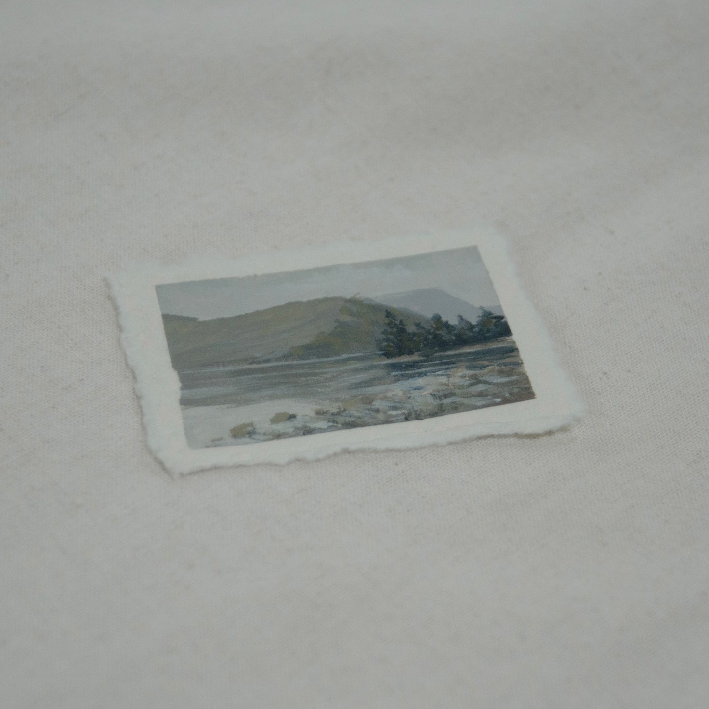 Side profile of miniature original landscape of Lake McDonald painted in Glacier National Park