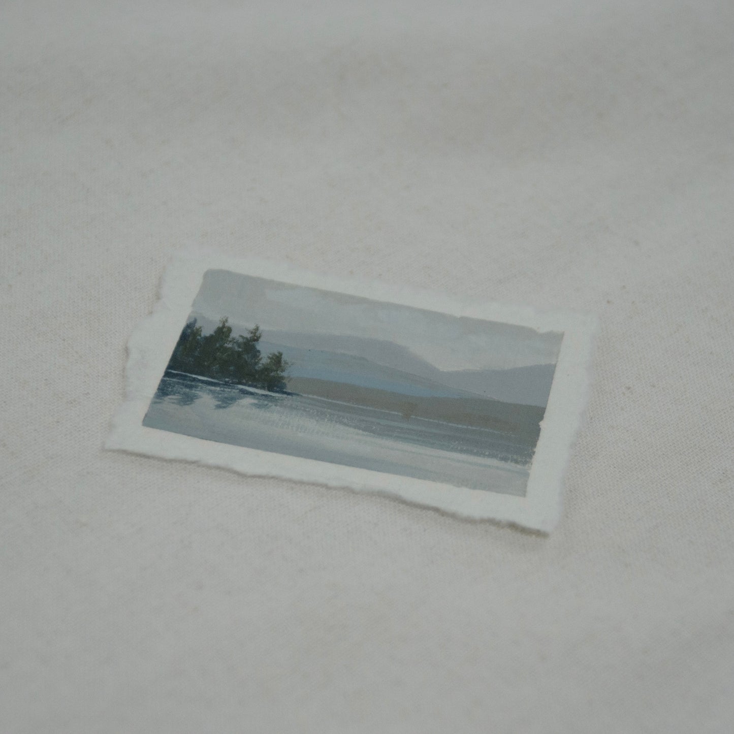 Side profile of Lake McDonald in Glacier National Park painting on deckled edge 100% cotton rag paper.