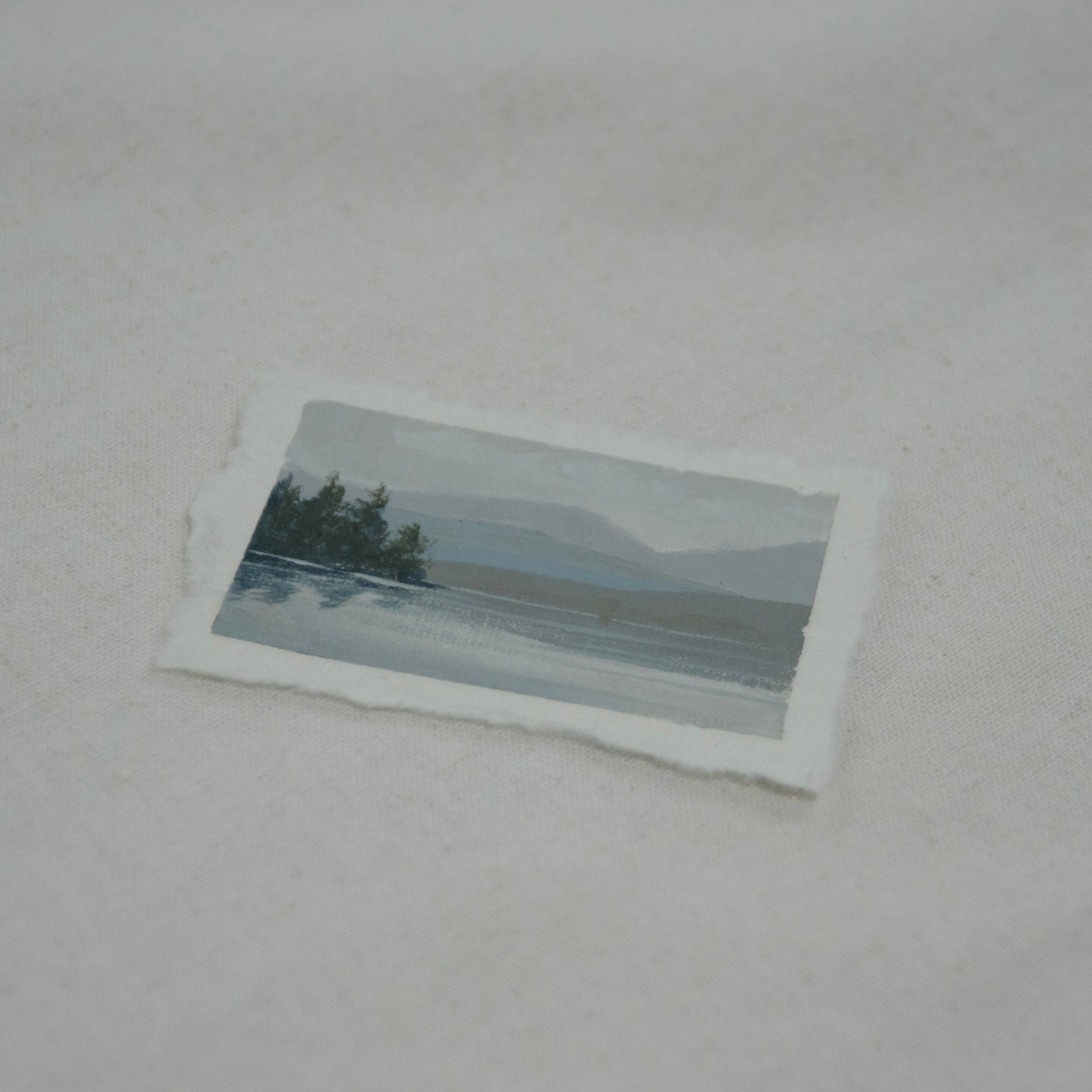 Side profile of Lake McDonald in Glacier National Park painting on deckled edge 100% cotton rag paper.