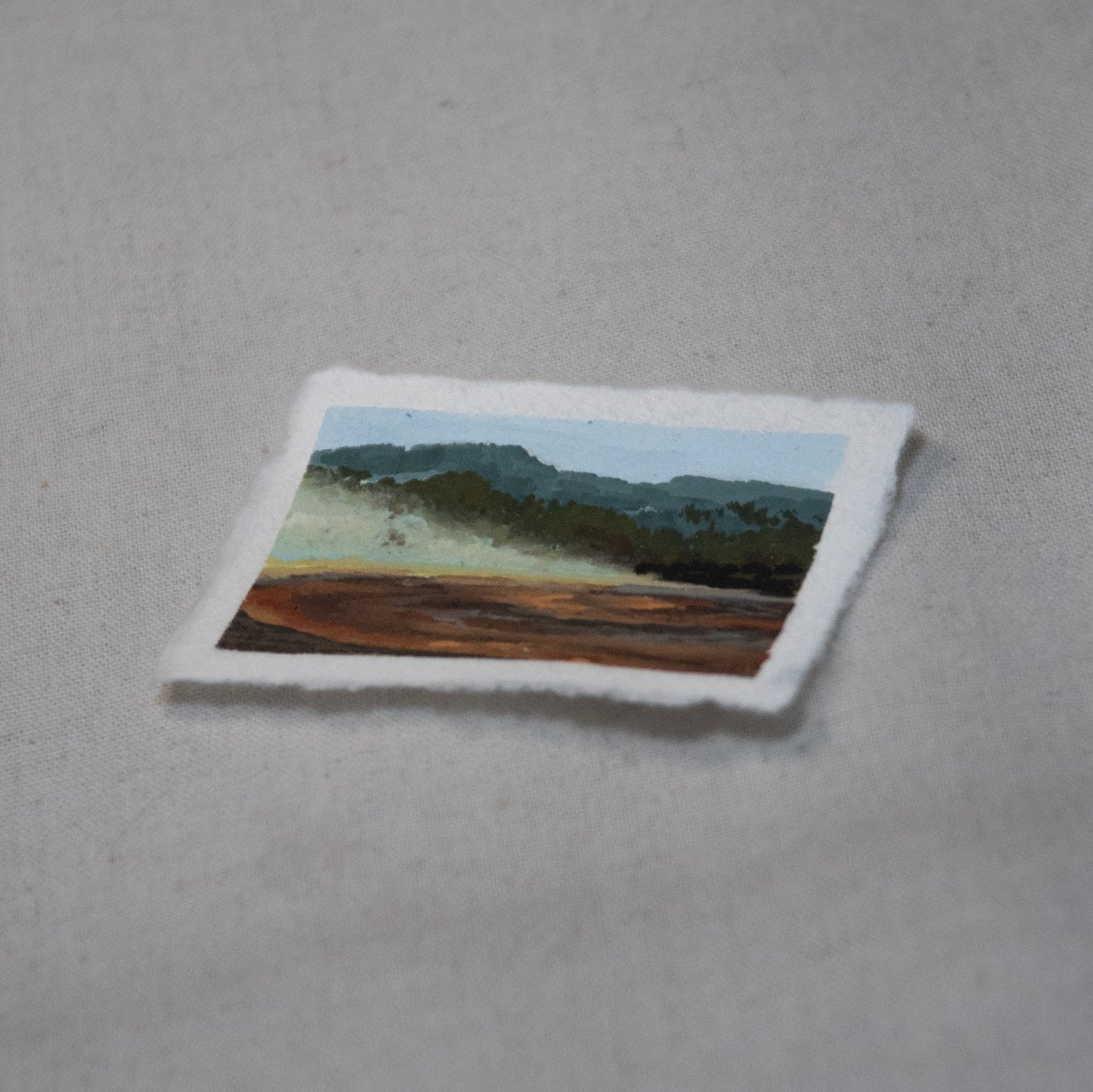 Side profile of Rainbow Hot Spring Yellowstone painting on deckled edge 100% cotton rag paper.