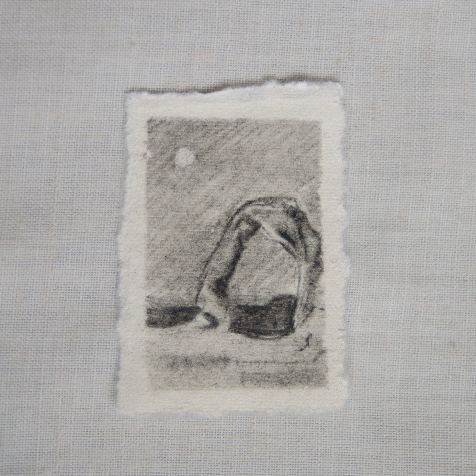 A sketch of Delicate Arch in Arches National Park on deckled edge paper with visible charcoal and pencil strokes by Laura Van Moorleghem for 'for the land' collection