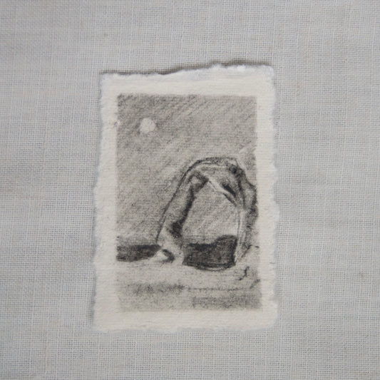 A sketch of Delicate Arch in Arches National Park on deckled edge paper with visible charcoal and pencil strokes by Laura Van Moorleghem for 'for the land' collection