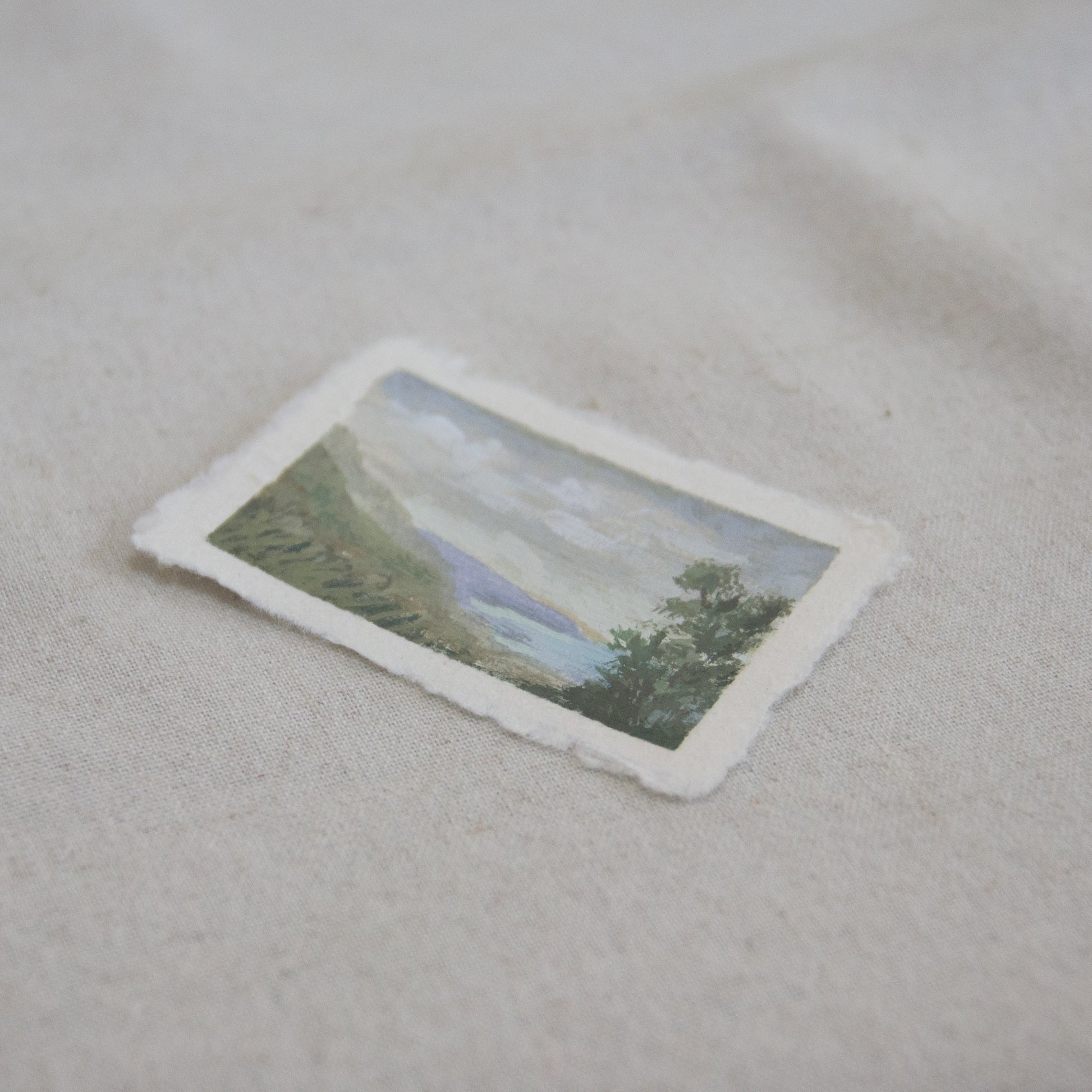 Side profile of a mini painting of mountainscape and ocean of Channel Islands National Park  on deckled edge 100% cotton rag paper