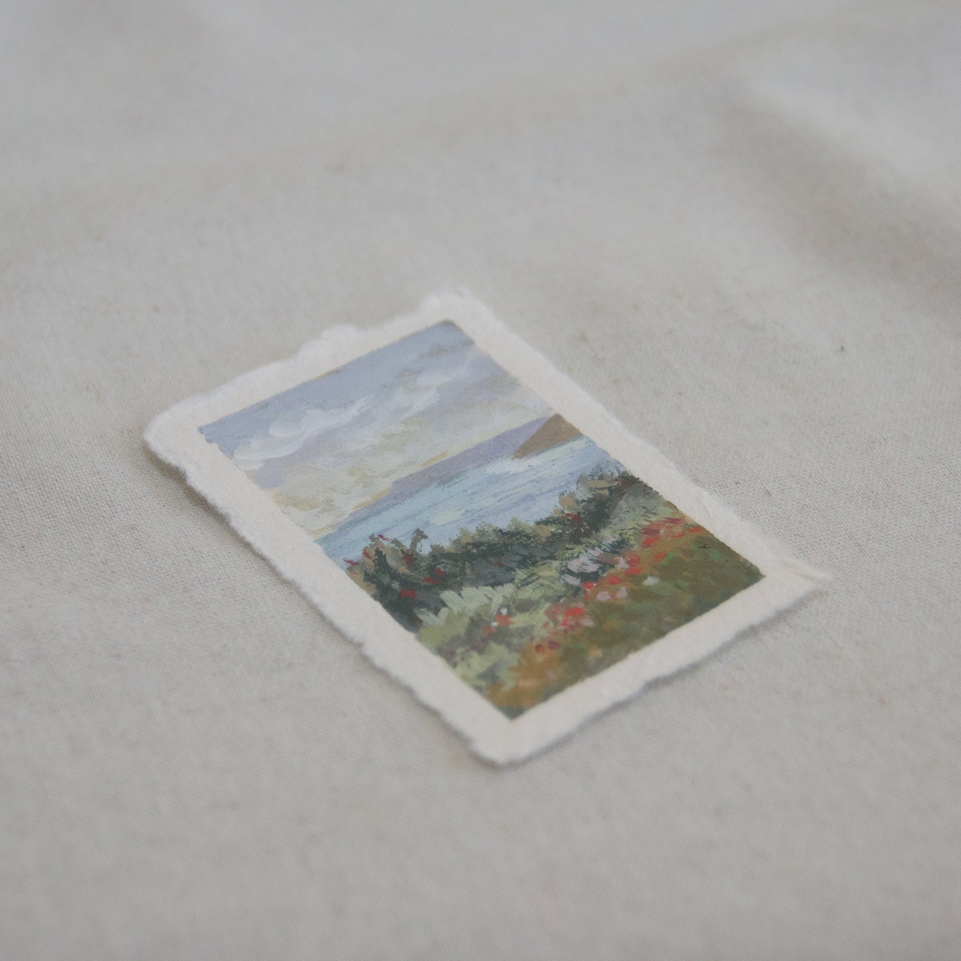 Side profile of an overlook of Channel Islands National Park with flowers and coastal blue scene mini painting on deckled edge 100% cotton rag paper
