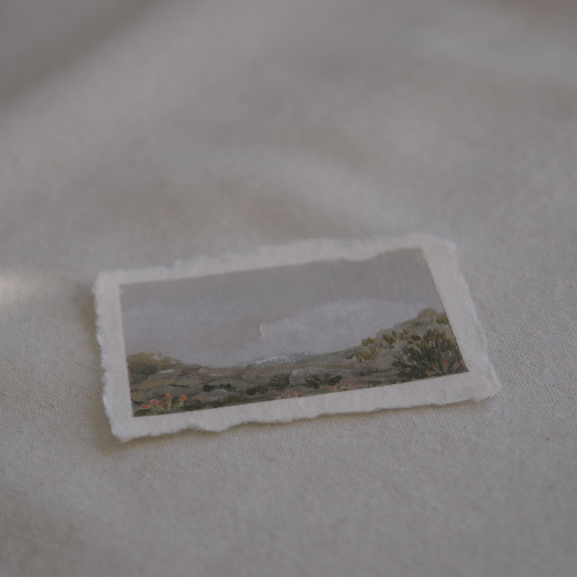 Side profile of mountains, granite boulders, and cactus from cholla cactus garden in Joshua Tree National Park painting on deckled edge 100% cotton rag paper
