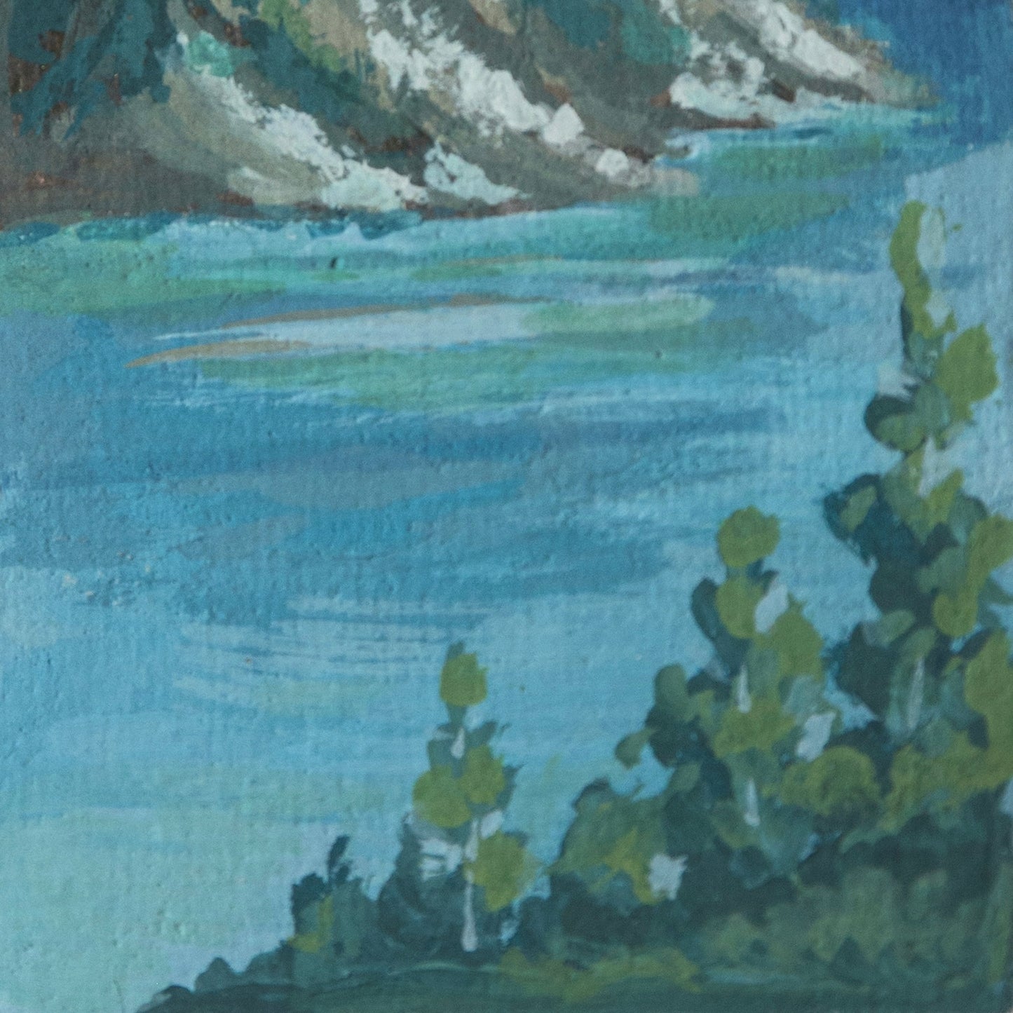 Close up detail of miniature painting of a mountain landscape with trees and water of Crater Lake in Crater Lake National Park