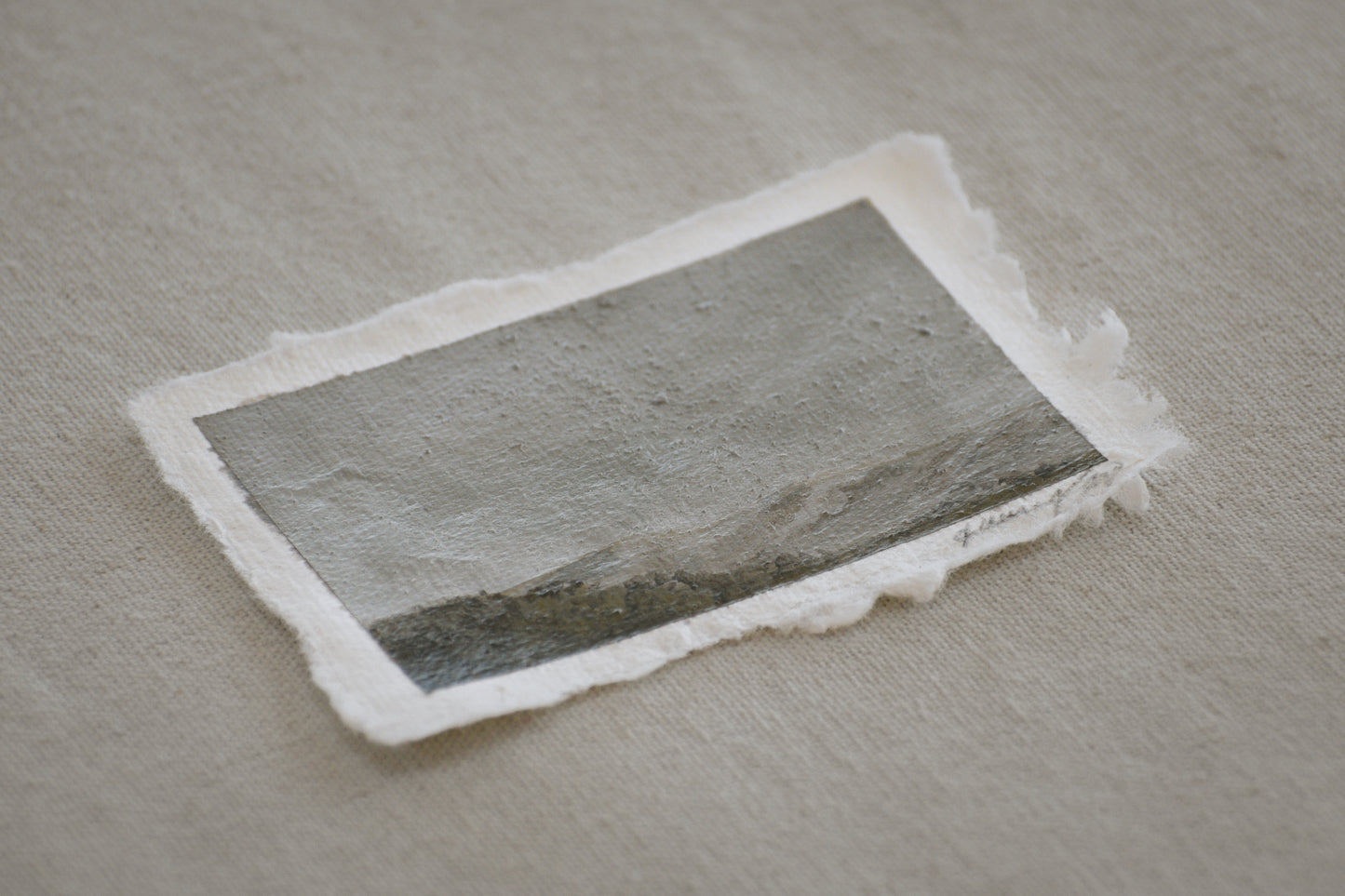 Side profile of mini Great Sand Dunes and grass fields painting on deckled edge 100% cotton rag paper with embedded sand from the National Park