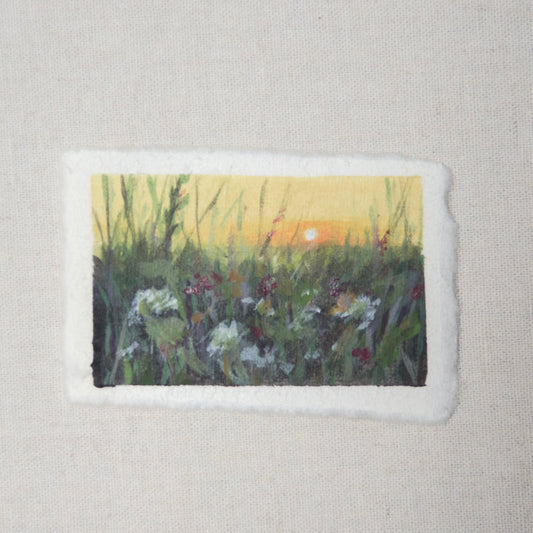 A small painting depicting a floral field with a deckled edge on 100% cotton rag paper by Laura van Moorleghem