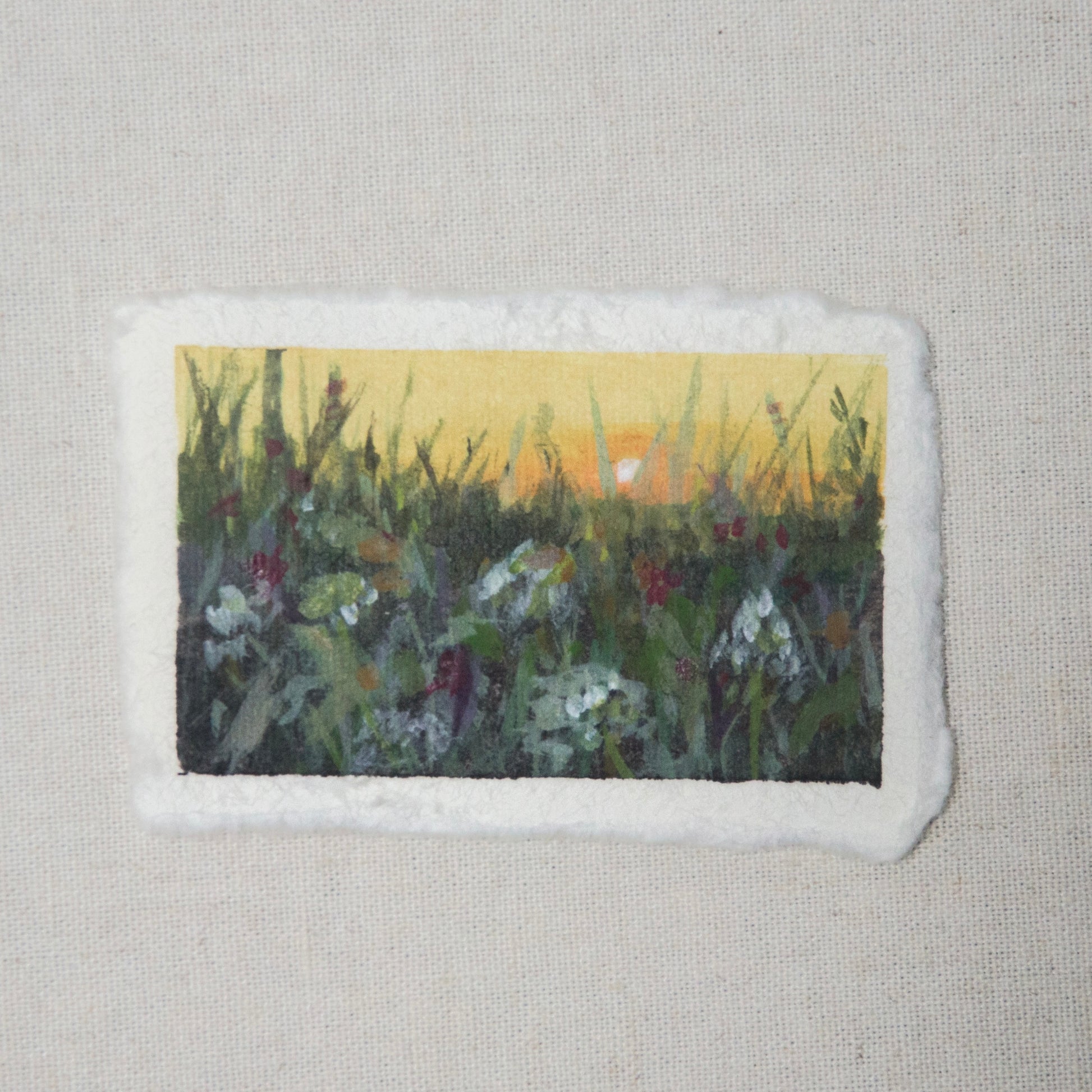 A small painting depicting a floral scene at sunset with a deckled edge on 100% cotton rag paper by Laura van Moorleghem 