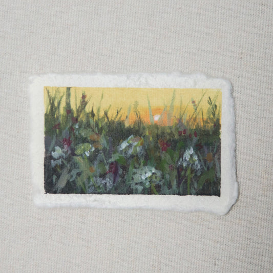 A small painting depicting a floral scene at sunset with a deckled edge on 100% cotton rag paper by Laura van Moorleghem 
