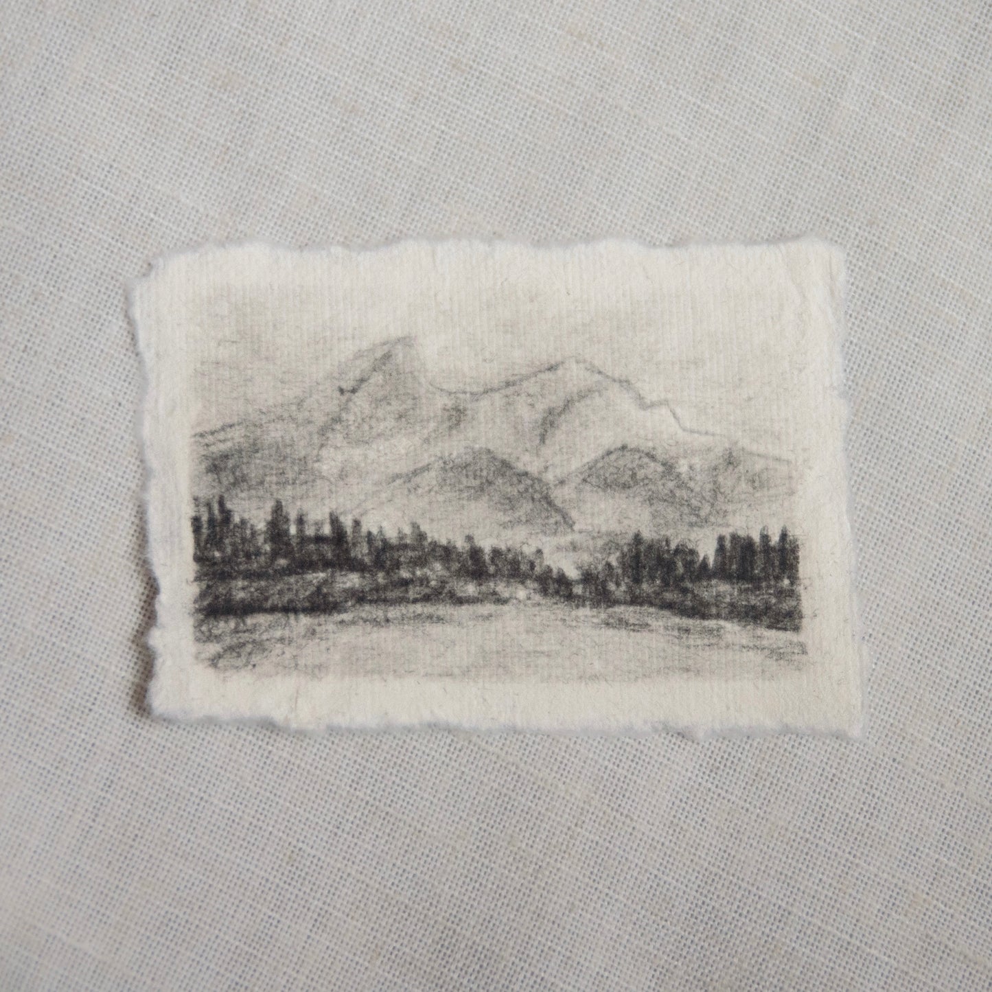 A charcoal sketch of Grand Teton mountains in Grand Teton National Park on deckled edge paper, part of the collection 'For the Land'.