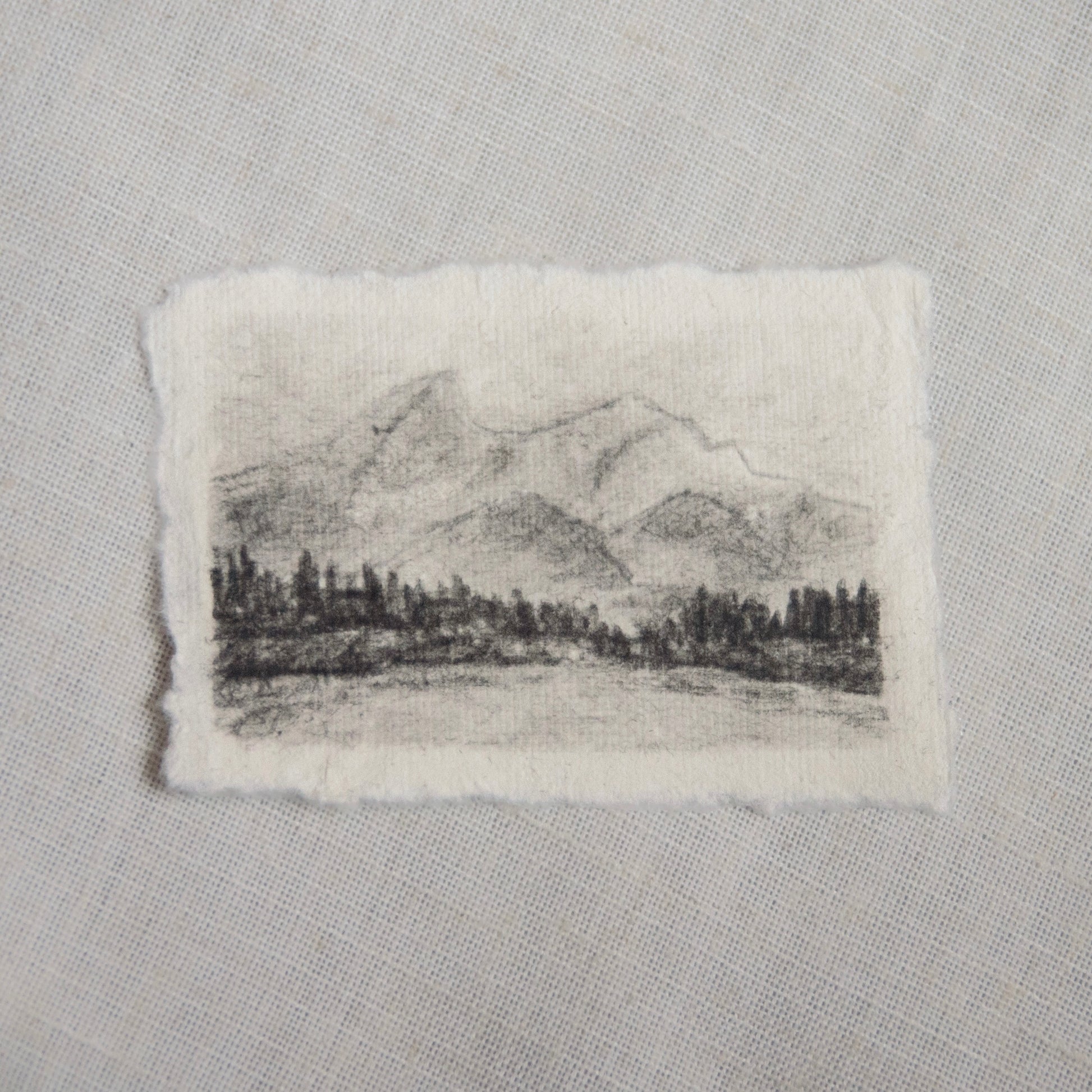 A charcoal sketch of Grand Teton mountains in Grand Teton National Park on deckled edge paper, part of the collection 'For the Land'.