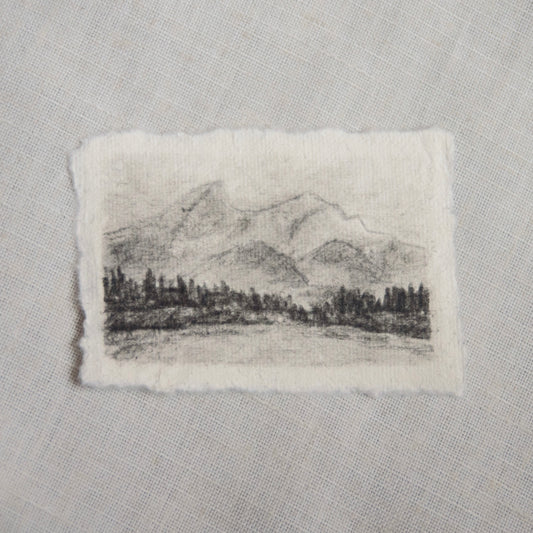 A charcoal sketch of Grand Teton mountains in Grand Teton National Park on deckled edge paper, part of the collection 'For the Land'.