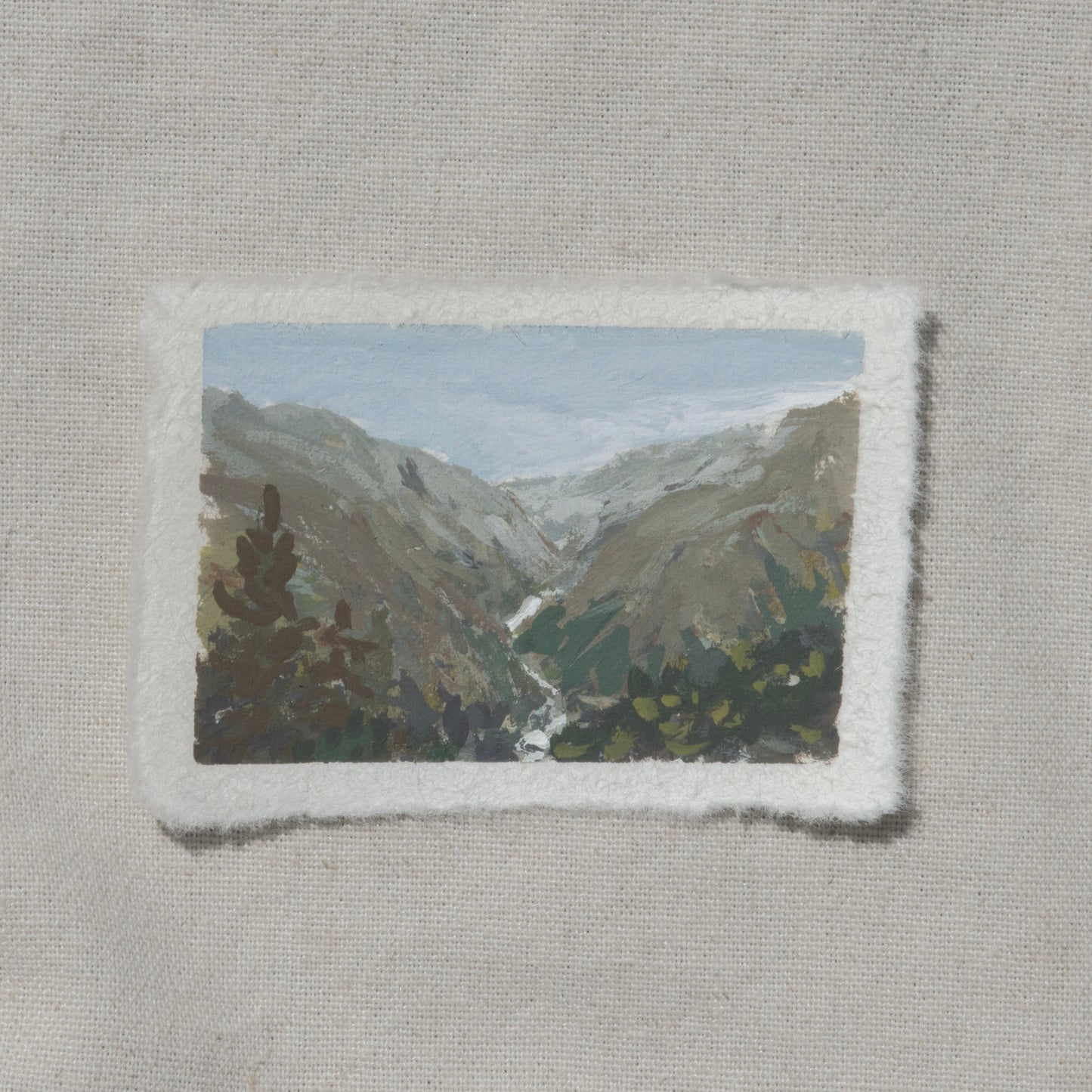 A miniature gouache painting on cotton rag paper with a deckled edge, depicting the mountainous landscape of Junction view overlook in Kings Canyon National Park, by Laura van Moorleghem