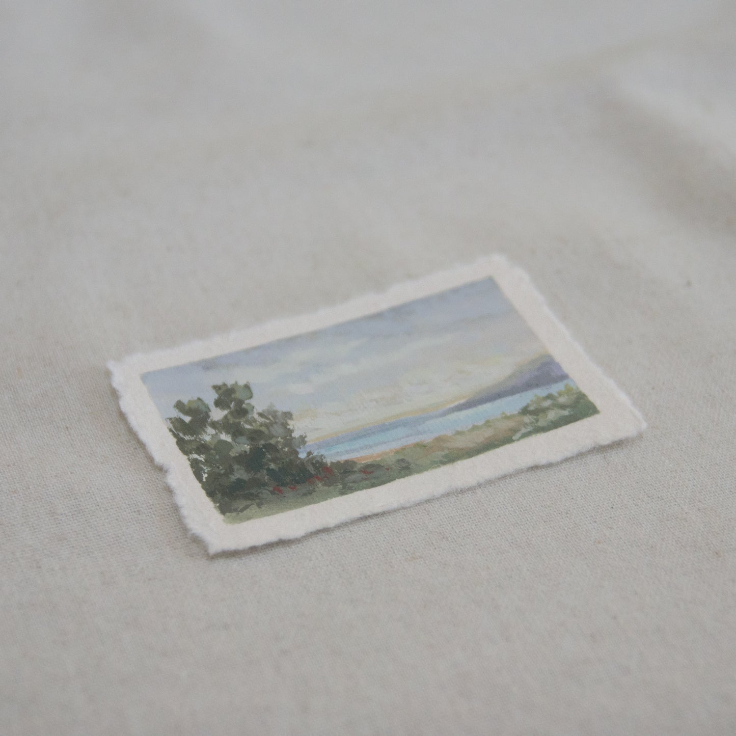 Side profile of a mini painting of trees and ocean in Channel Islands National Park  mini painting on deckled edge 100% cotton rag paper