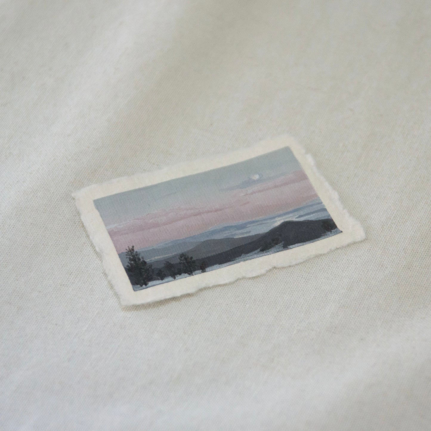 Side profile of overlook at Lassen Volcanic National Park of lakes and mountains during sunset painting on deckled edge 100% cotton rag paper