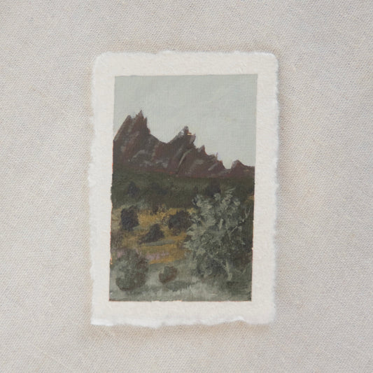 A miniature painting depicting pinnacles and trees, executed in a soft, impressionistic style on deckled edge paper in acrylic. created in Pinnacles National park by artist Laura Van Moorleghem