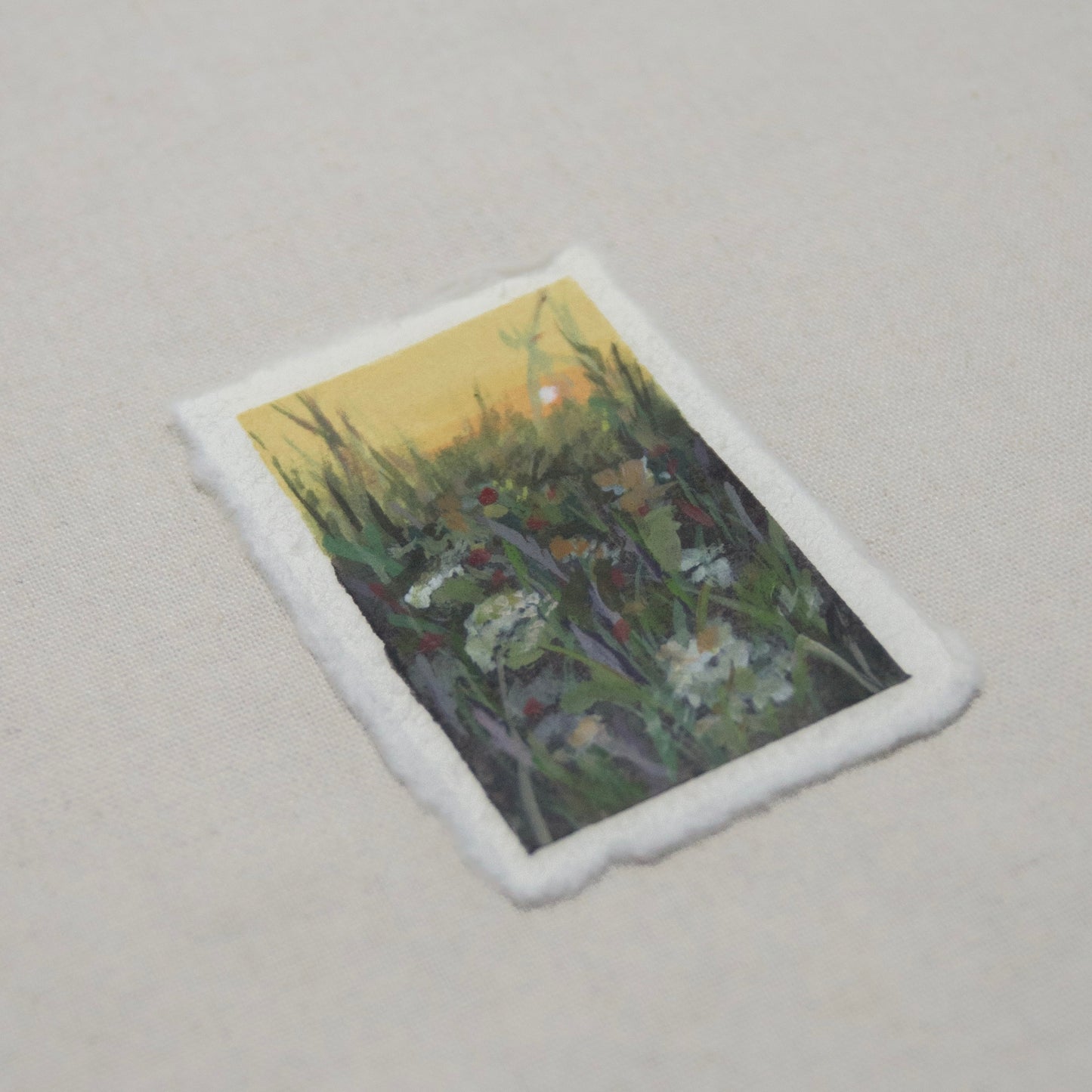 side profile of a mother's day mini painting gift, art depicting a floral field at sunset