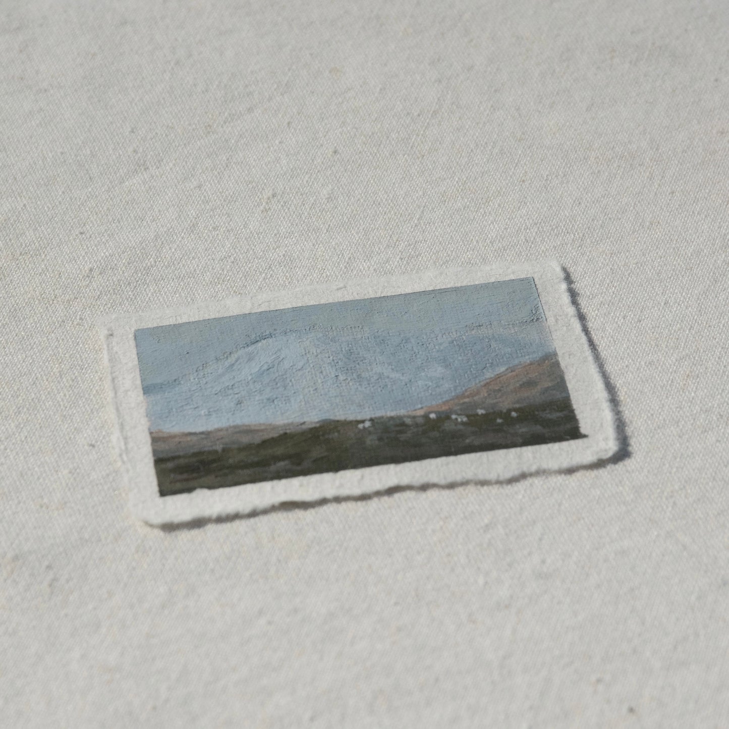 Side profile of mountain goats in the distance facing mount rainier in Mount Rainier National Park painting on deckled edge 100% cotton rag paper