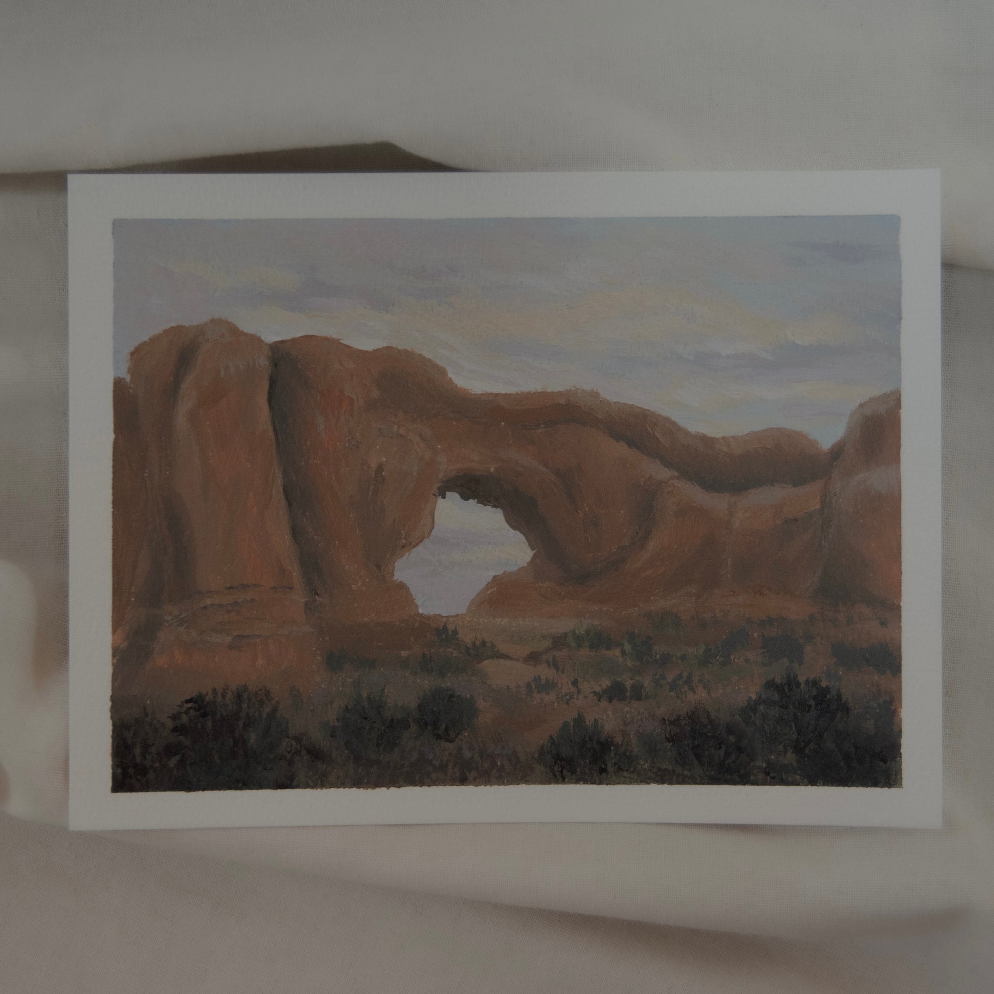 A painting of the North Window arch in Arches National Park, with acrylic and gouache on cotton paper