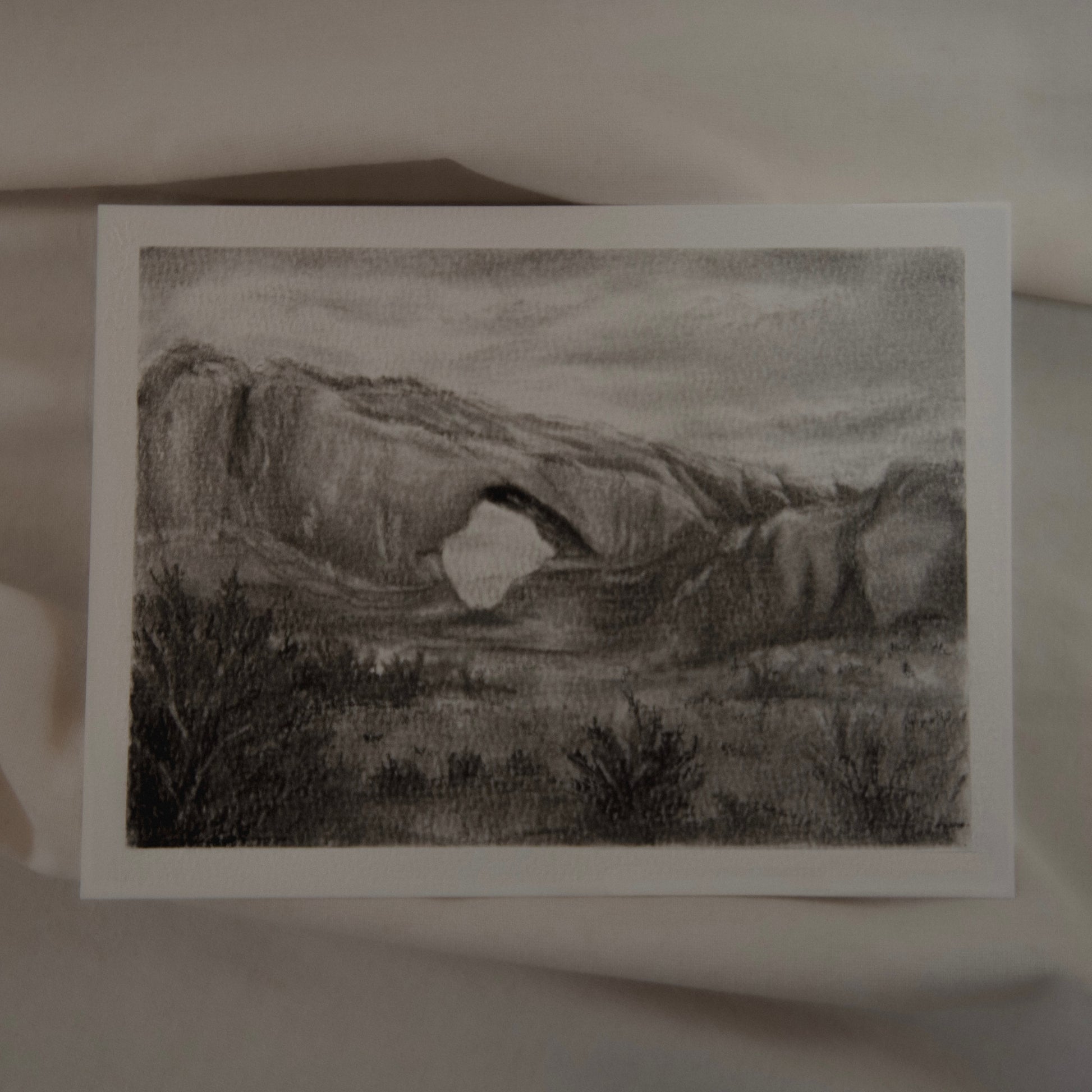 A charcoal and pencil drawing of a landscape, North Window study, with a view of a large rock formation by artist Laura van Moorleghem