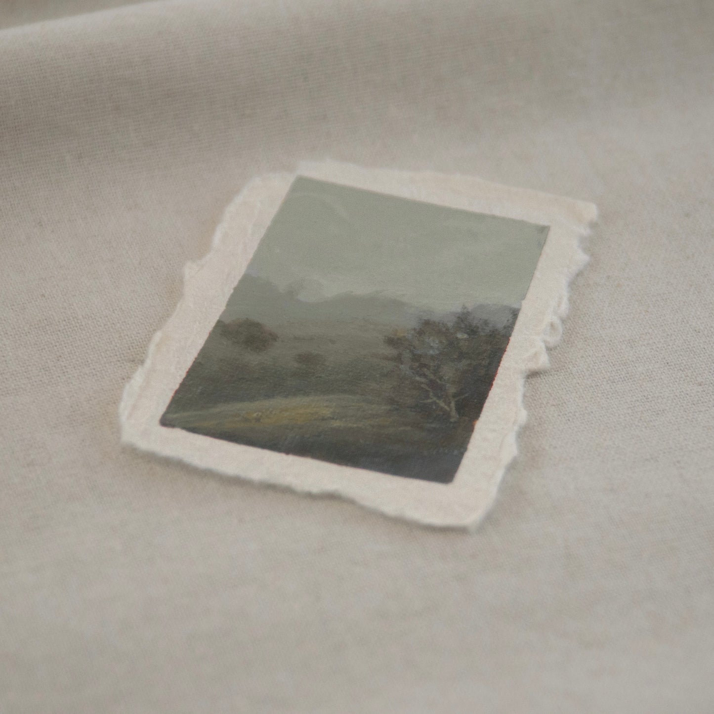 Side profile of pinnacle peaks in a foggy distance with dappled tree on a hillside miniature Pinnacles National Park painting on deckled edge 100% cotton rag paper