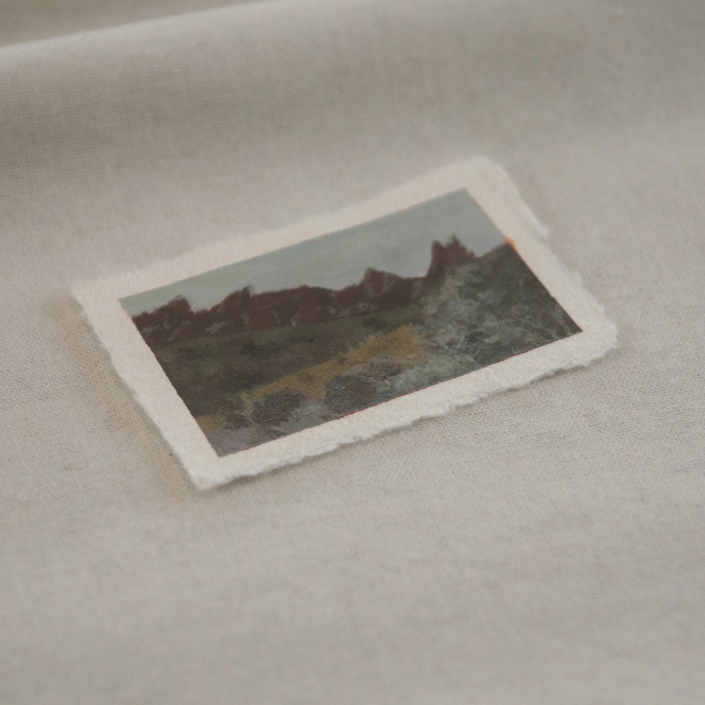 Side profile of pinnacles and hillsides of Pinnacles National Pakr miniature painting on deckled edge 100% cotton rag paper