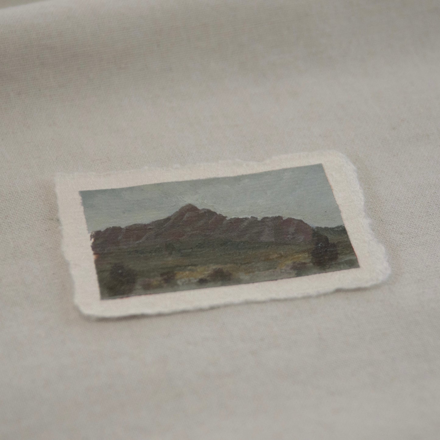 Side profile of pinnacle peaks and lush greenery acrylic painting on deckled edge 100% cotton rag paper