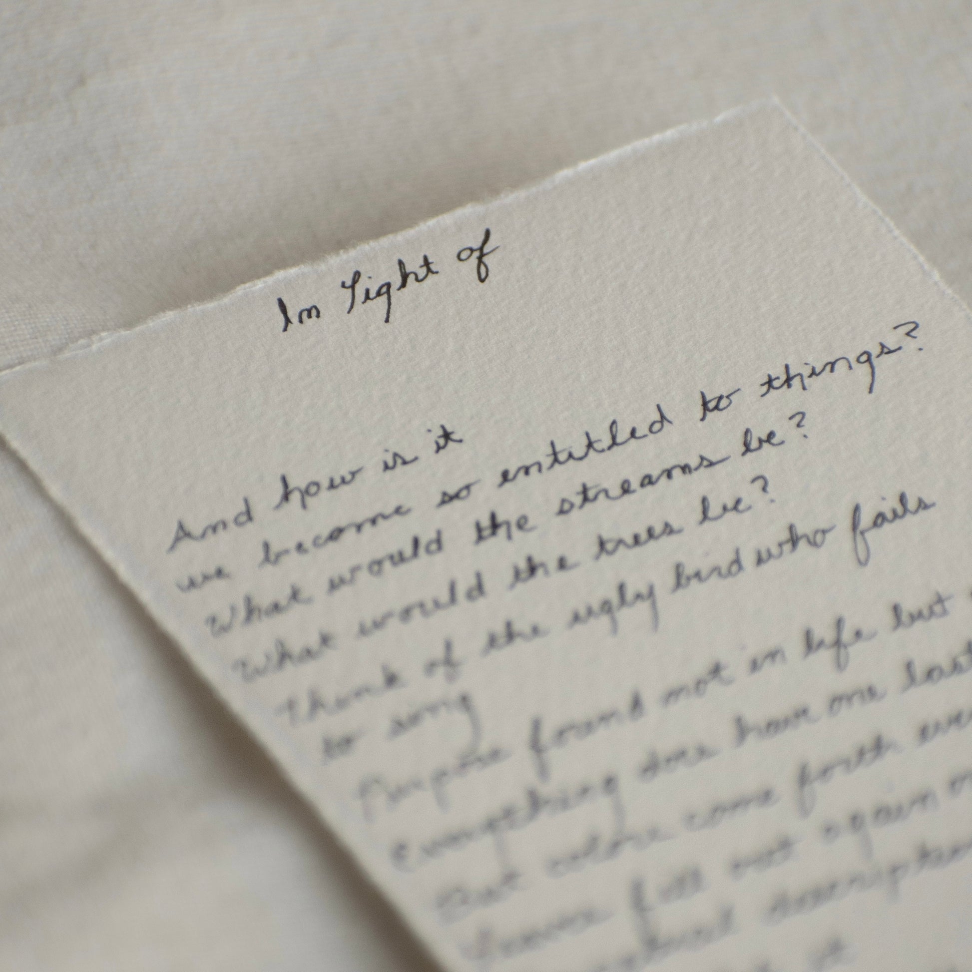close up of 'in light of' poem created while visiting Pinnacles National Park written in cursive on 100% cotton deckled edge 300 gsm paper. 