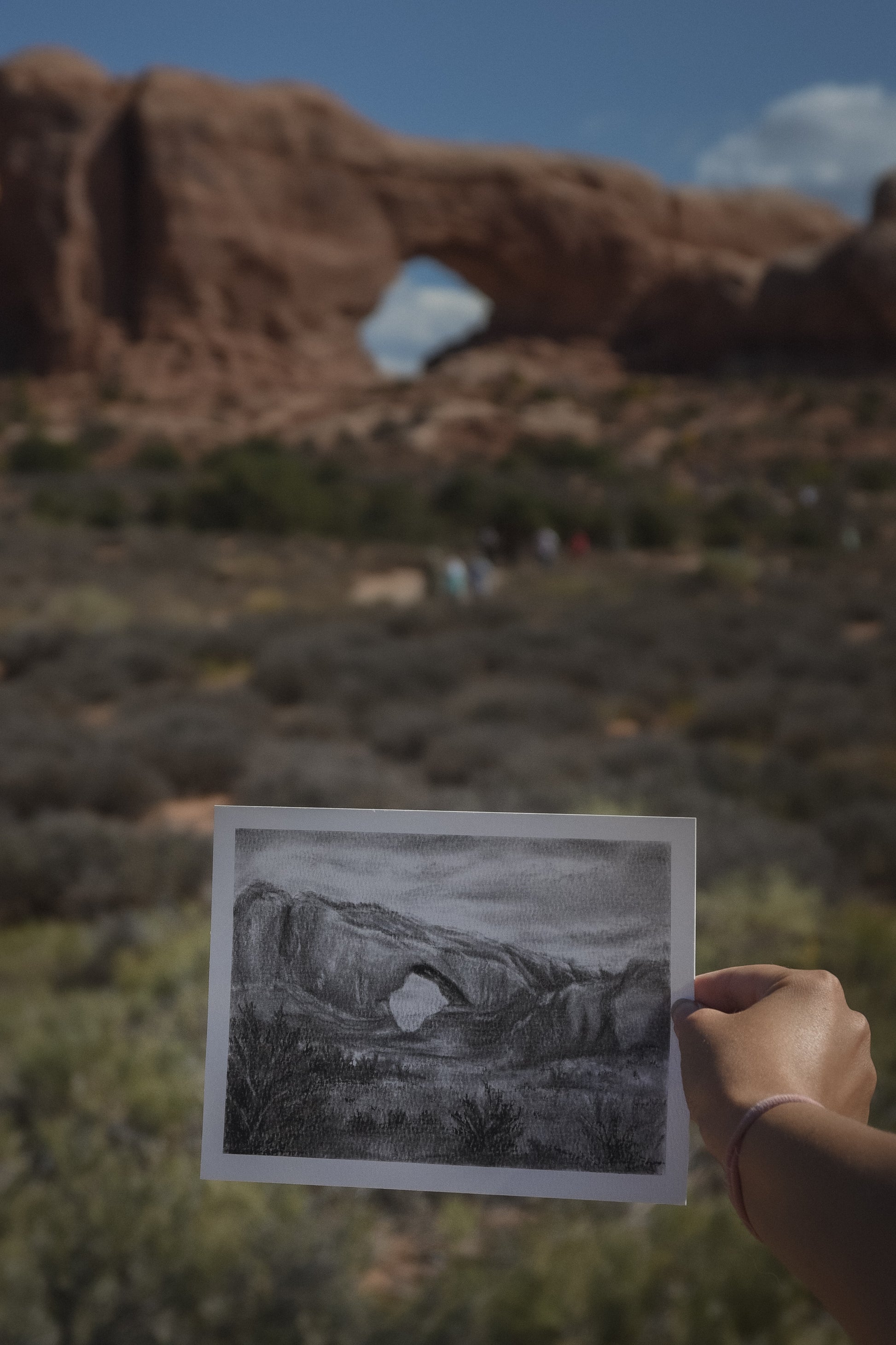 a charcoal study of north window being held up in arches national park location