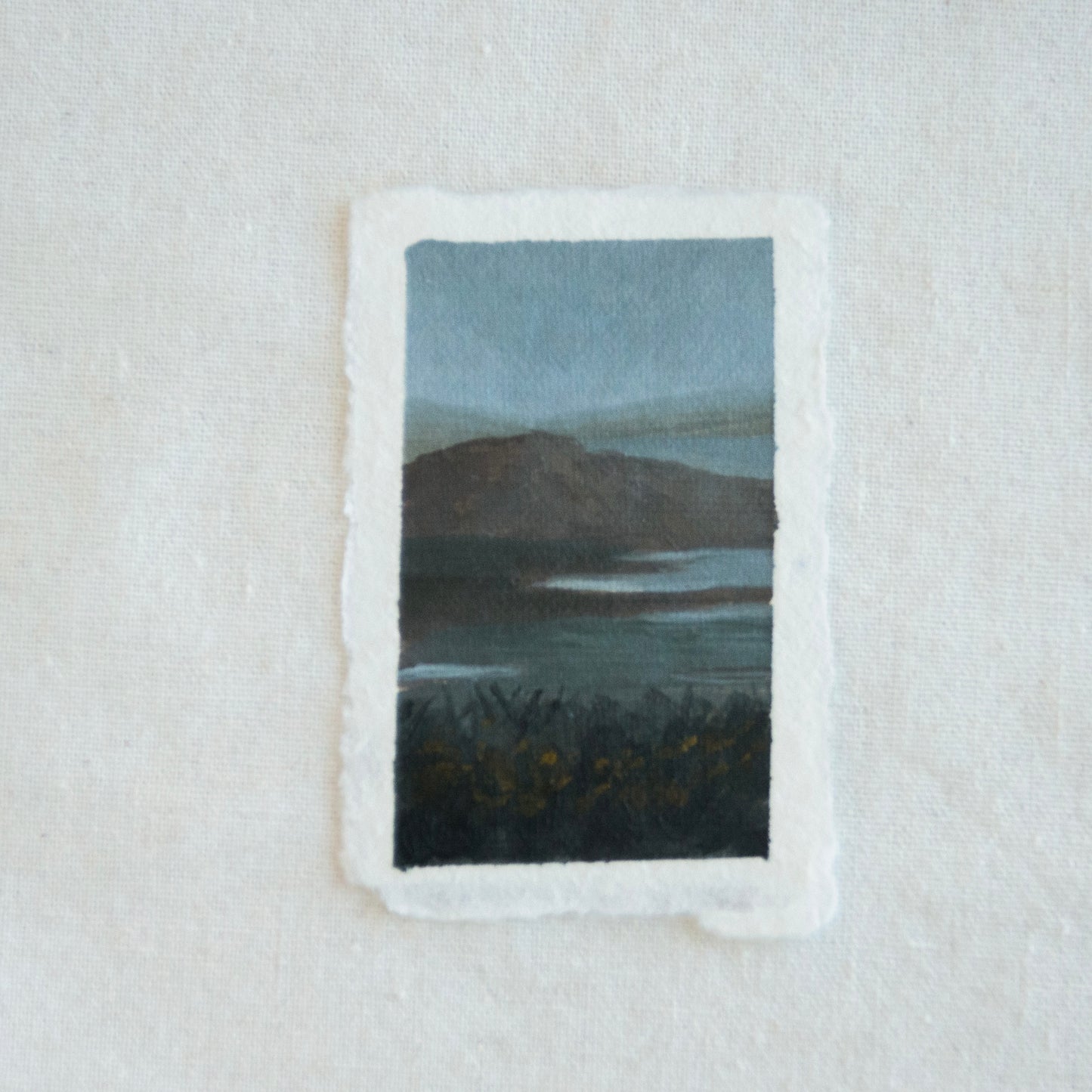Small painting of a landscape with a body of water and mountains created in Point Reyes National Seashore by Laura Van Moorleghem
