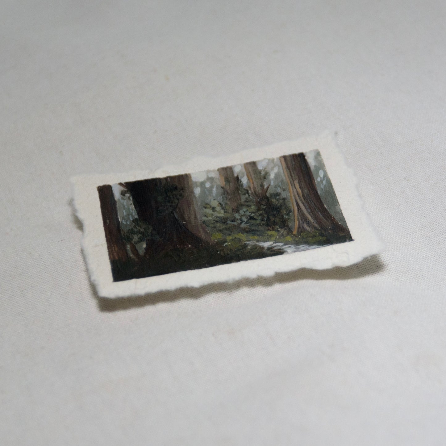 Side profile of redwood grove with creek painting on deckled edge 100% cotton rag paper