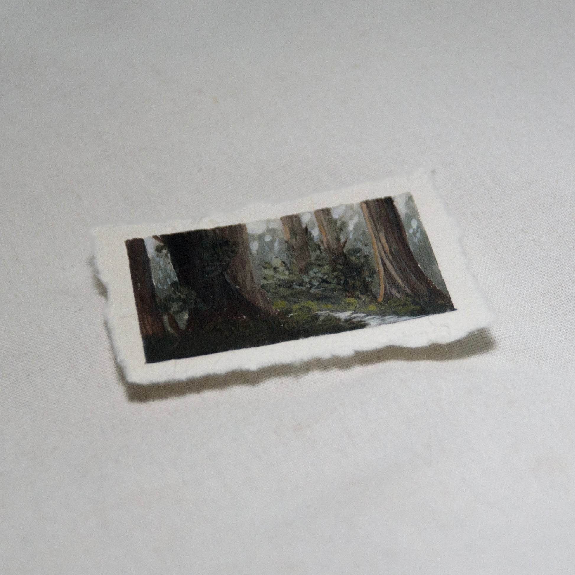 Side profile of redwood grove with creek painting on deckled edge 100% cotton rag paper