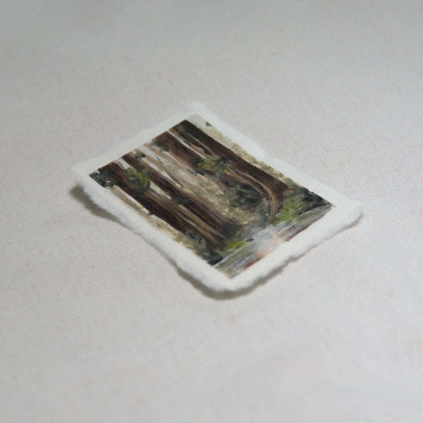 Side profile of redwood grove with creek painting on deckled edge 100% cotton rag paper