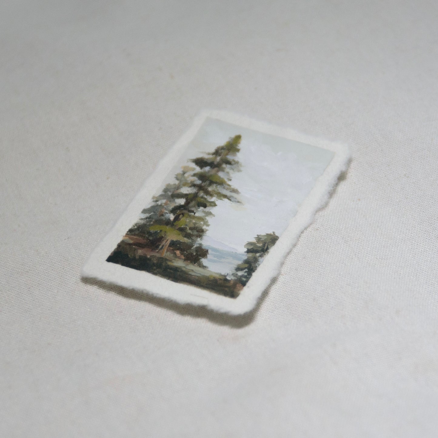 Side profile of redwood oceanscape painting on deckled edge 100% cotton rag paper