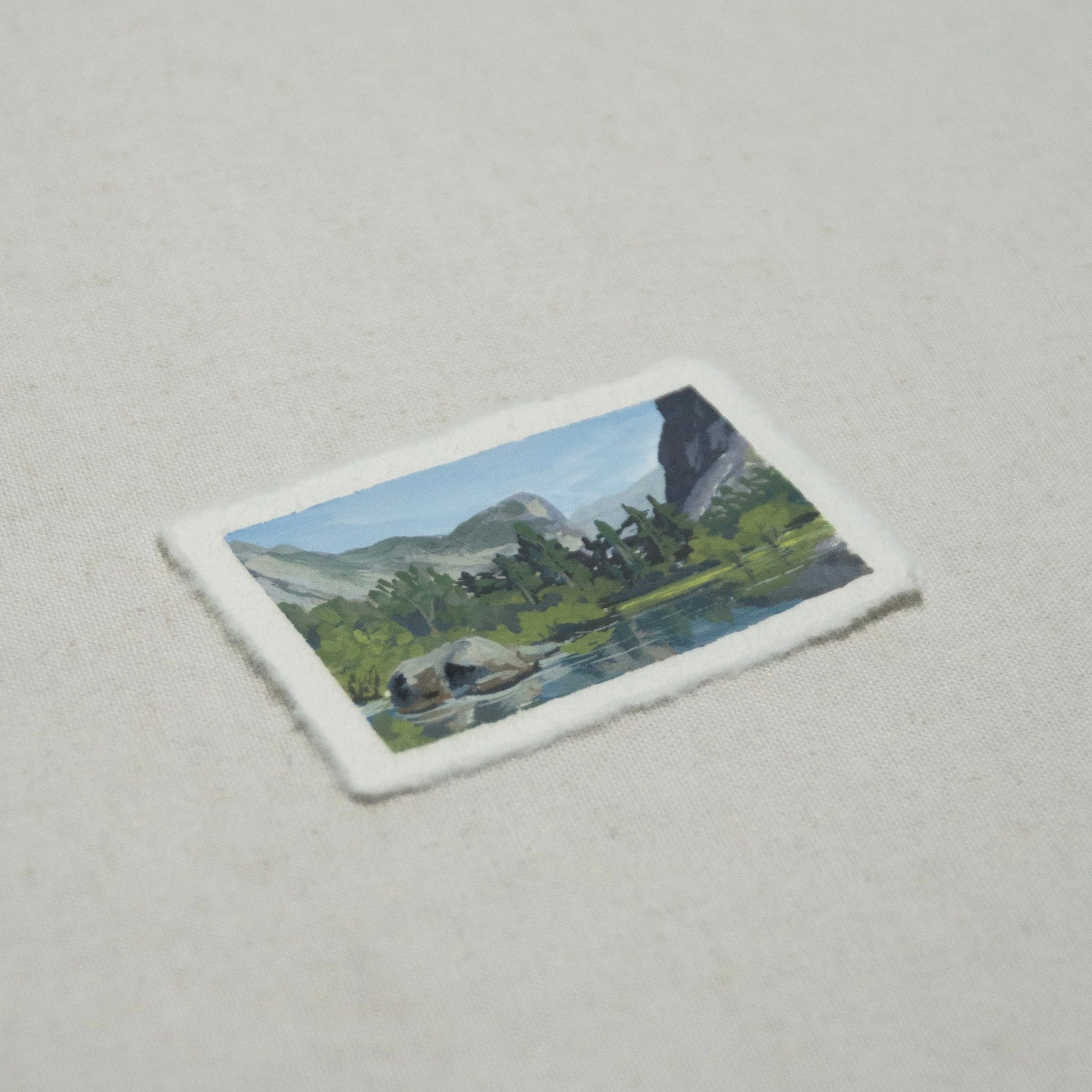 Side profile of Reflection Lake painting on deckled edge 100% cotton rag paper.