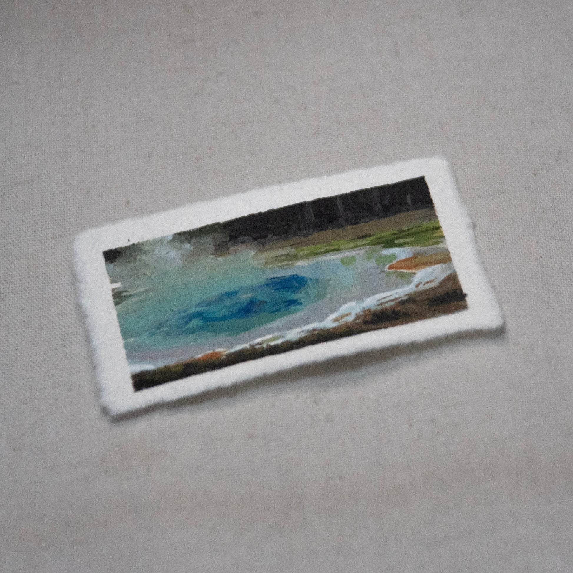 Side profile of Sapphire Geothermal pool Yellowstone painting on deckled edge 100% cotton rag paper.