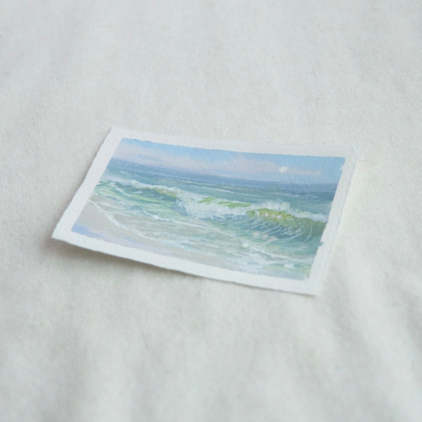 Side profile of seafoam and large wave in gulf islands national seashore painting on deckled edge 100% cotton rag paper