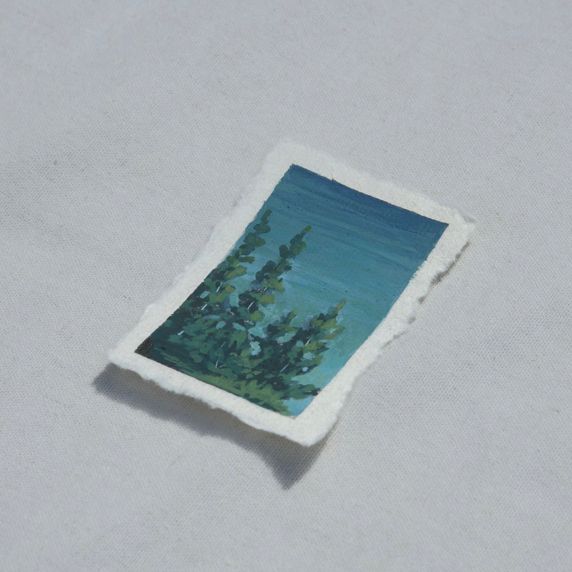 Side profile of Crater Lake National Park overlook with pine trees painting on deckled edge 100% cotton rag paper