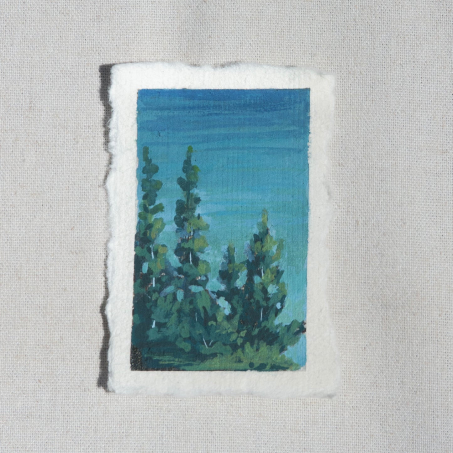 Mini gouache landscape of crater lake blues and pine trees overlooking crater lake by Laura Van Moorleghem from Crater Lake National Park