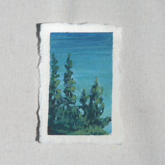 Mini gouache landscape of crater lake blues and pine trees overlooking crater lake by Laura Van Moorleghem from Crater Lake National Park