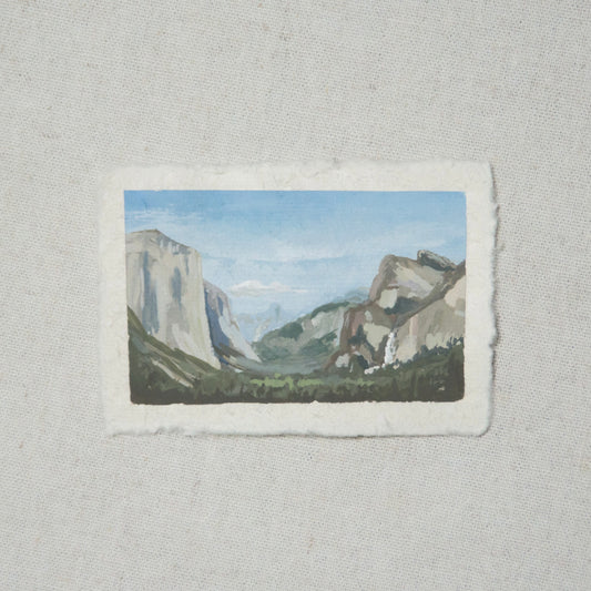 A miniature painting depicting a landscape view of Yosemite National Park Tunnel View, featuring mountains and sky, executed in gouache on deckled edge paper.