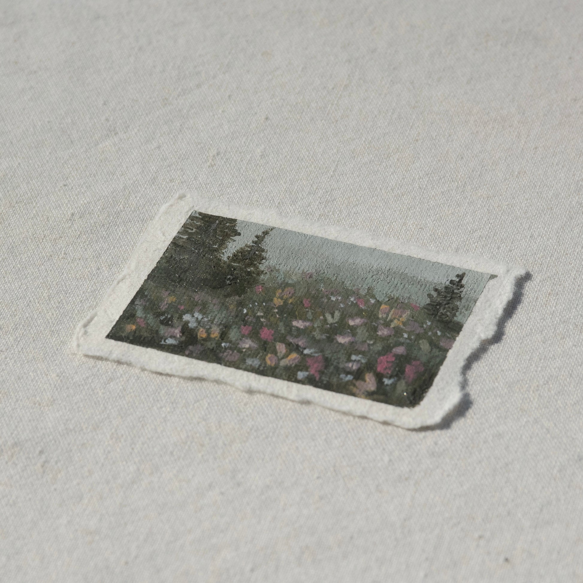 Side profile of mount rainier pine tree and wildflower field painting on deckled edge 100% cotton rag paper