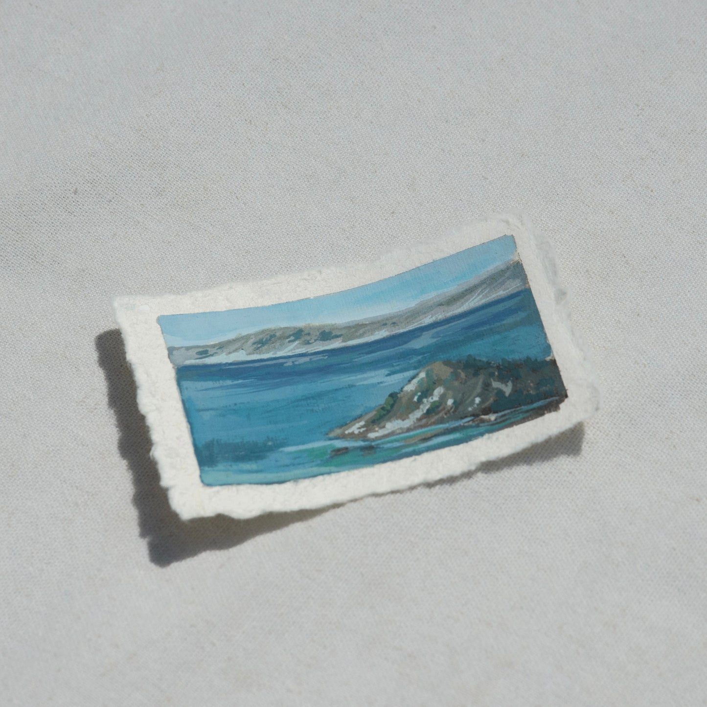 Side profile of wizard island at an overlook in Crater Lake National Park painting on deckled edge 100% cotton rag paper